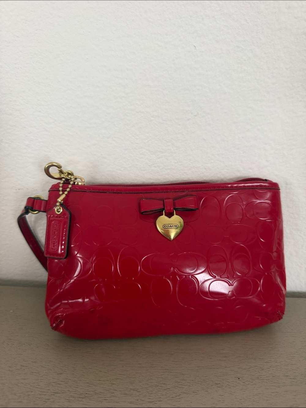 COACH Red Patent Signature Wristlet with Gold Heart Charm